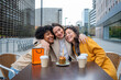 © Miquel - Three happy women celebrating birthday at an outdoor cafe