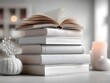 © Yusro - A minimalist stack of clean books featuring an open book beside a decorative vase and subtle candlelight.