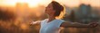 © Lady O - A woman with her arms outstretched, enjoying the fresh air and sunshine on a summer day, in a panoramic banner.
