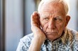 © Prazis Images - Portrait of a Troubled Senior Man with Hearing Difficulties