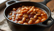 © Toyama Digital Art - Homemade Boston Baked Beans in a rustic cast iron cocotte on a wooden table, traditional American comfort food