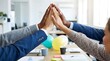 © pkproject - Four diverse hands high fiving in celeb n of a successful team achievement in a modern office setting
