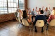 © Rawpixel.com - Team meeting with raised hands.