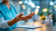 © Kateryna - Close up of a hand in bright scrubs gesturing warmly toward a patient in a well lit clinic examination room the hand showing a reassuring open palm gesture a medical chart and