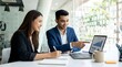 © ABUDARDA - Diverse colleagues collaborating on business growth charts in modern office