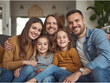 © FOYSALHOQUE - Happy smiling family with two children sitting together at home