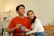 © MIND AND I - Young Asian Couple Sharing a Loving Moment with Coffee at Home