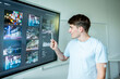 © Halfpoint - Teen boy presenting school project in front of classroom.