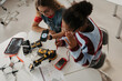 © Halfpoint - High school students working on robotics project. Girls in STEM.
