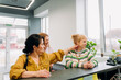 © m-art - Three women enjoy a joyful moment together in a bright and modern reception space. They smile and engage in light-hearted conversation, showcasing friendship and warmth.