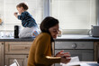 © Zoran Jesic - Mother multitasking working from home with child