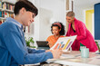 © ADDICTIVE STOCK - Women collaborating creatively in a modern office