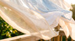 © Arlen - Light, transparent linen curtains flutter in the gentle breeze of a sunny gazebo, a carefree, airy atmosphere of a warm summer, a sunny terrace, a gazebo in the garden, a hot summer morning