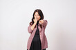 © Sino Images Studio - Cheerful woman laughing and pointing at camera