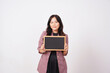 © Sino Images Studio - Confident Woman Holding Empty Small Blackboard in Front of Body
