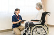 © buritora - A female caregiver interviews a senior woman in a wheelchair.