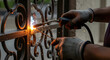 © Letcia - Man repairing iron gate in front of house home maintenance manual work fixing metal structure and residential routine scene.