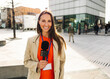 © Westend61 - Smiling reporter with microphone conducting interview outdoors