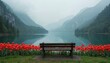 © miss irine - Empty wooden bench overlooks tranquil lake with red tulips. Misty mountains rise behind serene blue water. Peaceful natural landscape view in spring.