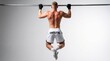 © ahmad - A muscular man wearing gloves performs pull-ups on a bar in a gym
