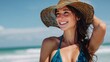 © Harry - A beautiful woman wearing a straw hat and smiling at the beach on a sunny day.