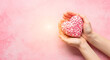 © Aklima - Heartfelt mother day gift hands holding a beautiful pink heart shaped treat for a loving celebration