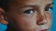 © Z A C - Boy with freckles looking intently at the camera.