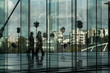 © yaqui_villegas - Reflections on a glass facade reveal silhouettes of pedestrians in corporate business finance architecture at La Defense Paris within a modern office district scene