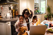 © Marko Geber - Mother with two daughters taking selfie at breakfast in home kitchen