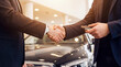 © Aurora Aesthetics - automotive handshake dealership sales purchase agreement negotiation trust contract success in bright showroom as buyer and consultant finalize premium vehicle deal with reliable service and approval