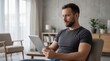 © ArtMajestic - Man sitting in armchair using digital tablet at home. Serious guy reading news or browsing internet on screen. Relaxed lifestyle and remote communication technology in modern interior