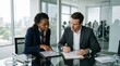 © Ryzhkov - Diverse business professionals reviewing digital documents on a tablet in a modern office, legal team collaboration with copy space on a glass meeting table