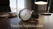 © Zipsteiger - Elegant luxury wristwatch on wooden desk with pen and lamp