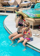 © yanadjan - Children eat watermelon near the pool. selective focus.