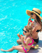 © yanadjan - Children eat watermelon near the pool. selective focus.