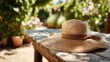 © zacty6 - Straw sun hat resting on a wooden table in a garden