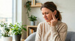 © Xenia - Woman suffering from jaw pain or toothache at home. Pained female touching face with uncomfortable expression