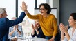 © GraphixStudio - Team celebrating a successful meeting with high-fives and applause