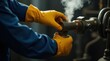 © Alex Pios - Industrial worker hand in protective glove turn valve with steam release. Focus on safety, machine operation, dark background, warm light