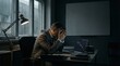 © Ammari - Stressed mature businessman looking at downward stock market crash chart on laptop in a dark moody office