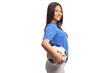 © Ljupco Smokovski - Young female football player holding a ball under her arm