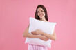 © New Africa - Beautiful woman with pillow on pink background. Space for text