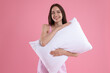 © New Africa - Beautiful woman with pillow on pink background