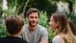 © Bussakon - Young adults gather in a lush green outdoor setting for a focused conversation and collaborative discussion