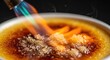 © jolly - Caramelizing Sugar in a Pan with Flame.