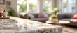 © gerald - Close-up of a marble countertop in a sunlit living room with blurred background