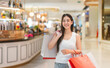 © dodotone - Portrait enjoy young adult asian woman holding shopping bags at indoor department store fashion and beauty consumerism lifestyle