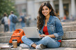© Varsha - Indian Female College Student Using Laptop Outdoors on Campus