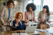 © Miljan Živković - Businesswomen discussing problems and collaborating during office meeting