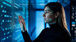 © Rendara Studio - Software developer woman reviewing code on digital interface in data center